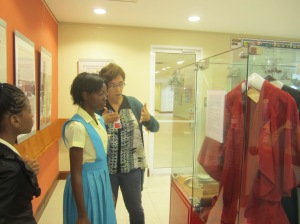 The Curator talks to students about one of the early UWI artifacts on display.
